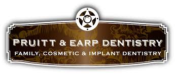 Ornate brown and gold sign that reads "Pruitt & Earp Dentistry, Family, Cosmetic & Implant Dentistry.